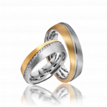 Обручальные кольца из комбинированного золота с дорожкой камней фото